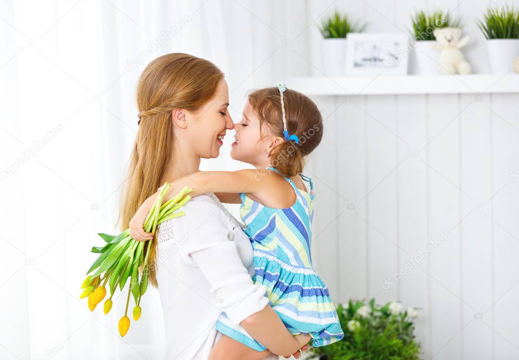 Happy mother's day! Child daughter congratulates moms and gives 