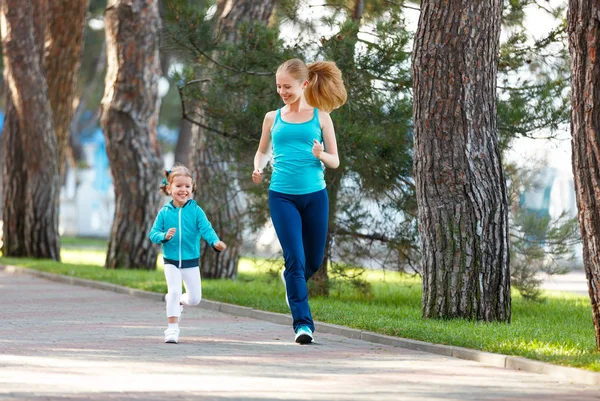 sport family. Mother and baby daughter jogging run on nature