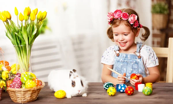 ¡Feliz Pascua! niña feliz pinta huevos para las vacaciones —  Fotos de Stock