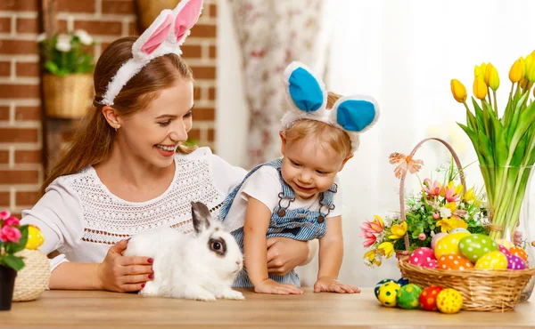 Feliz Páscoa! família mãe e bebê filho brincando com um coelho a — Fotografia de Stock