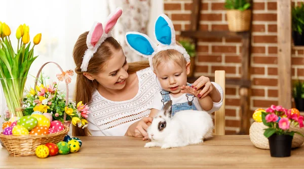 Happy easter! family mother and baby son playing with a rabbit a — Stock Photo, Image