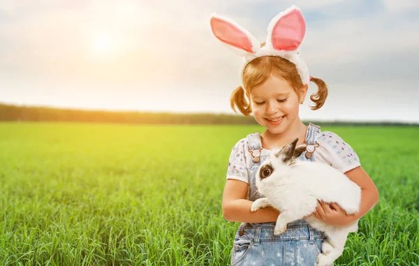 Happy easter! Pretty child girl with rabbit in nature — Stock Photo, Image