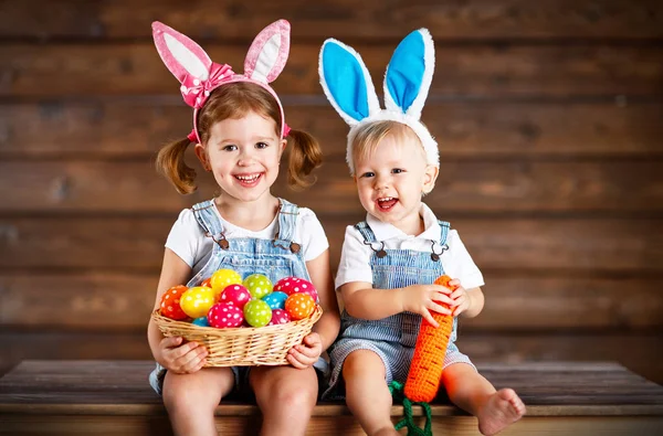 Feliz niño y niña vestidos como conejitos de Pascua con cesta de —  Fotos de Stock