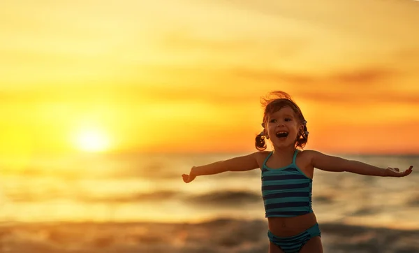 Happy child girl in bikini on beach in summer sea — Stock Photo, Image