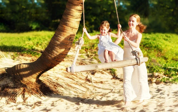 Happy family at beach. mother shook child on swing in summer — Stock Photo, Image
