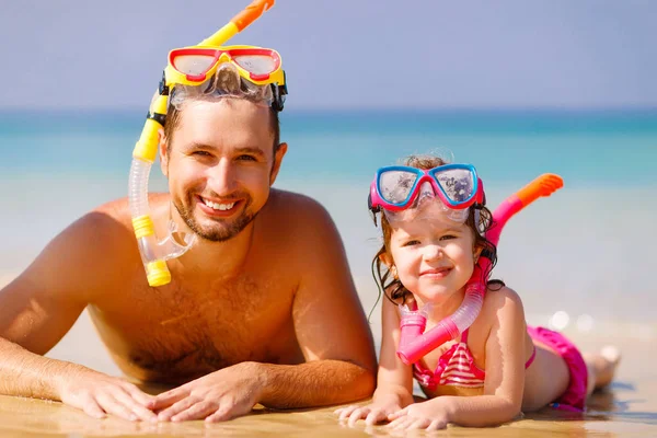Feliz familia padre e hijo con máscara y riéndose en la playa — Foto de Stock