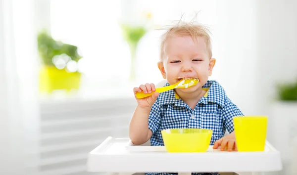 Happy baby eating himself — Stock Photo, Image