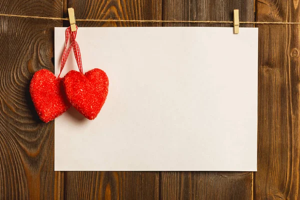 Tarjeta al día de San Valentín. hoja de papel en blanco y corazón rojo en —  Fotos de Stock