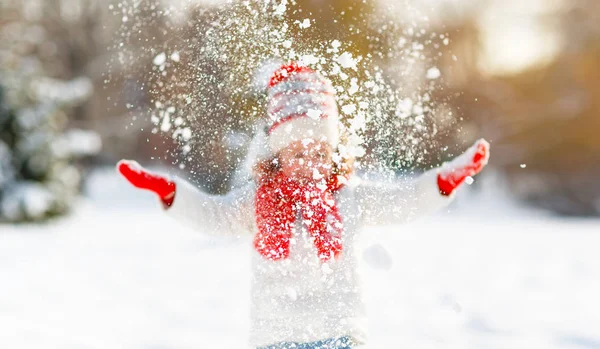 Happy child throws up snow on a winter walk — Stock Photo, Image