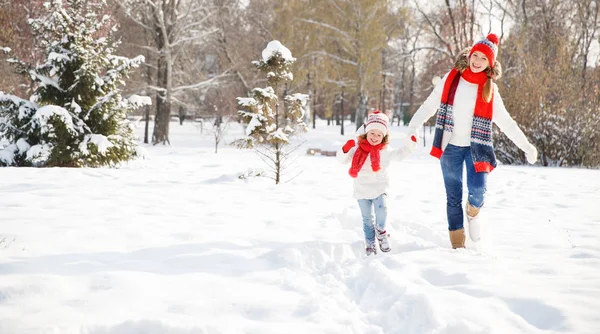 Happy family mother and child playing on winter walk — Stock Photo, Image