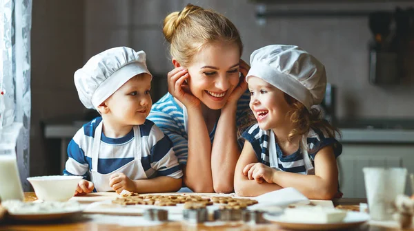 Família feliz na cozinha. mãe e filhos preparando massa, ba — Fotografia de Stock