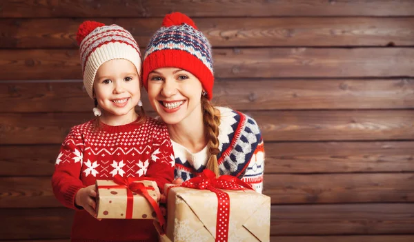 Happy family mother and child girl  with Christmas present on wo — Stock Photo, Image