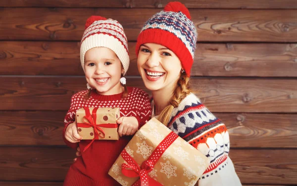 Happy family mother and child girl  with Christmas present on wo — Stock Photo, Image