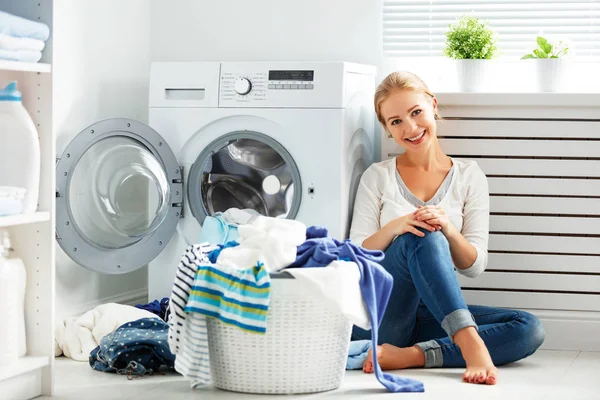 Šťastná žena v domácnosti v prádelně poblíž mači praní — Stock fotografie