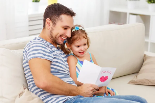 Father's day. Happy family daughter giving dad greeting card — Stock Photo, Image