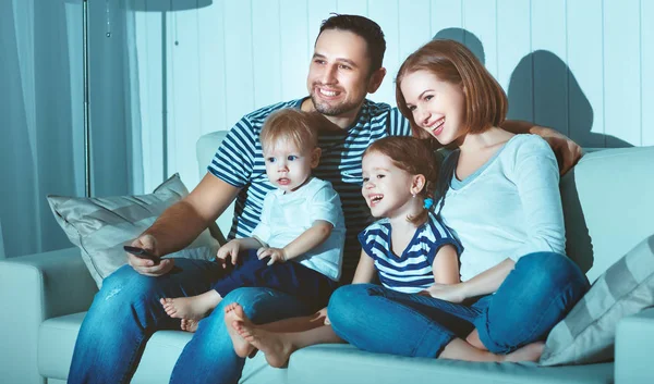 Family watching television at home on sofa — Stock Photo, Image