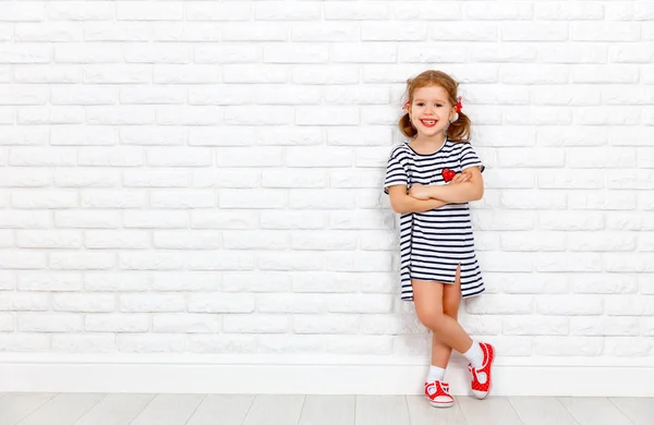 Happy laughing child girl near brick empty wall — Stock Photo, Image