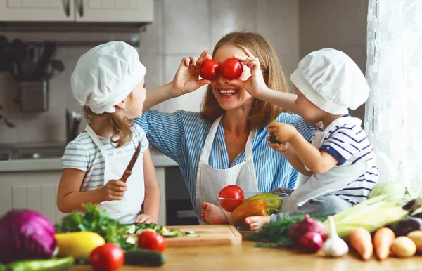 Gezond eten. Gelukkige familie moeder en kinderen bereidt veget — Stockfoto