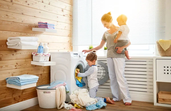 Happy family mother   housewife and children in   laundry load w — Stock Photo, Image