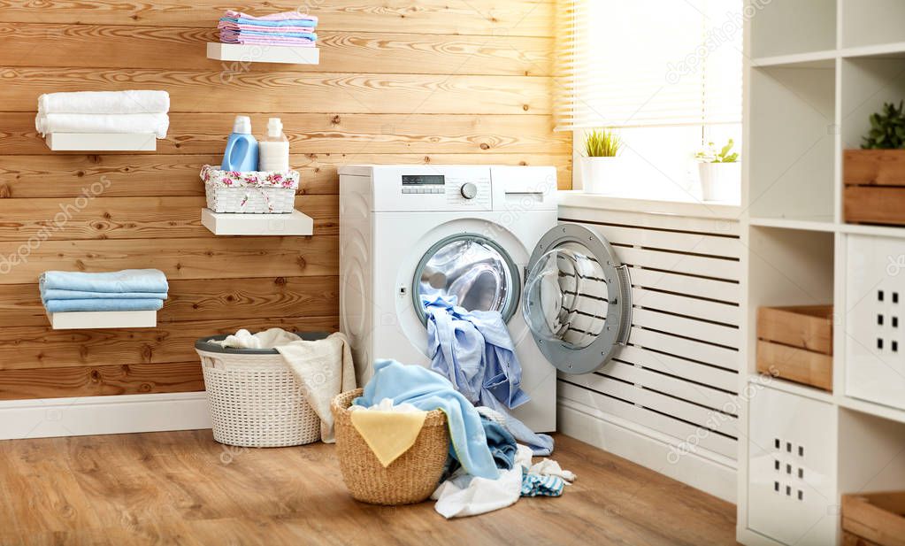 Interior of real laundry room with  washing machine at window at