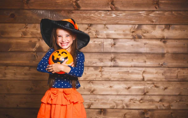 Divertida niña en traje de bruja en Halloween —  Fotos de Stock