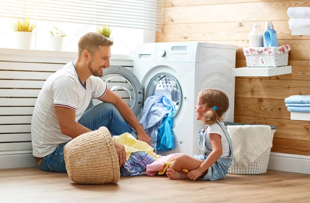 Happy family man father householder and child   in laundry with 