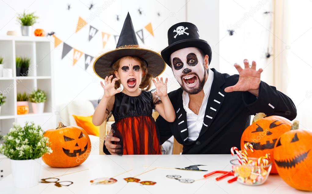 happy family father and child daughter in costumes   for hallowe