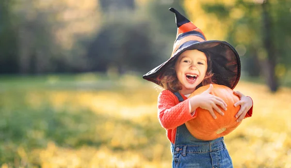 Crianças do dia das bruxas garotinho engraçado usando um chapéu de bruxa  com balões laranja e pretos feliz dia das bruxas