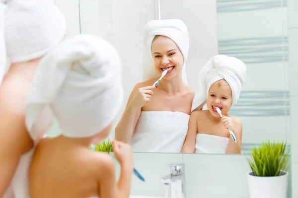 Moeder en kind dochter poetsen hun tanden met toothbrus — Stockfoto
