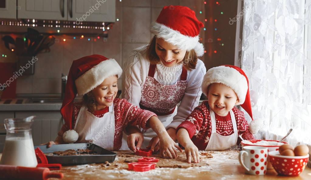 happy family mother and children  bake cookies for Christmas