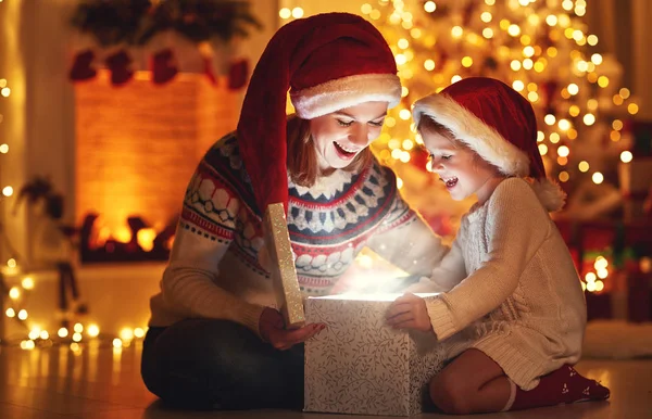 Merry Christmas! family mother and child with magic  gift  at ho Stock Picture