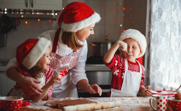 Happy family mother and children  bake cookies for Christmas — Stock Photo, Image