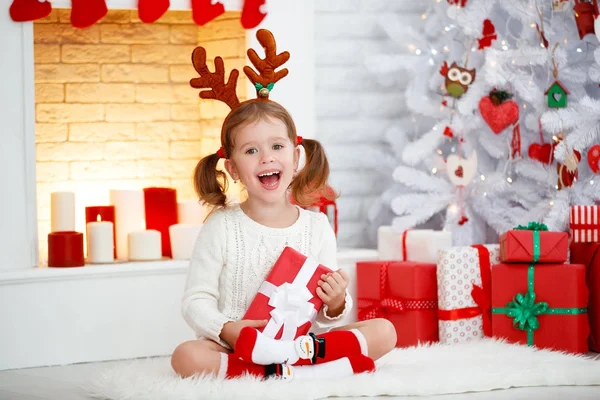 Lyckligt barn flicka med gåva i morgon på jul tre — Stockfoto