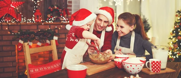 Family mother father and baby bake christmas cookies — Stock Photo, Image