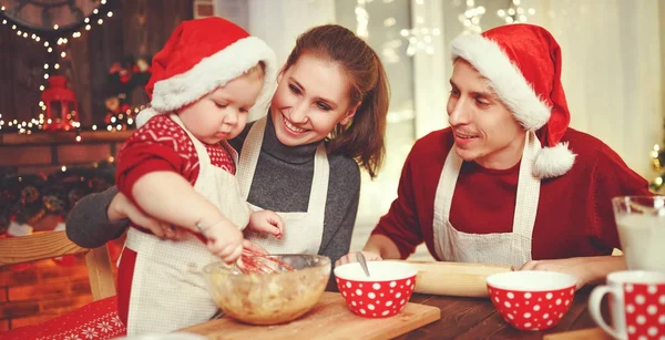 Family mother father and baby bake christmas cookies — Stock Photo, Image