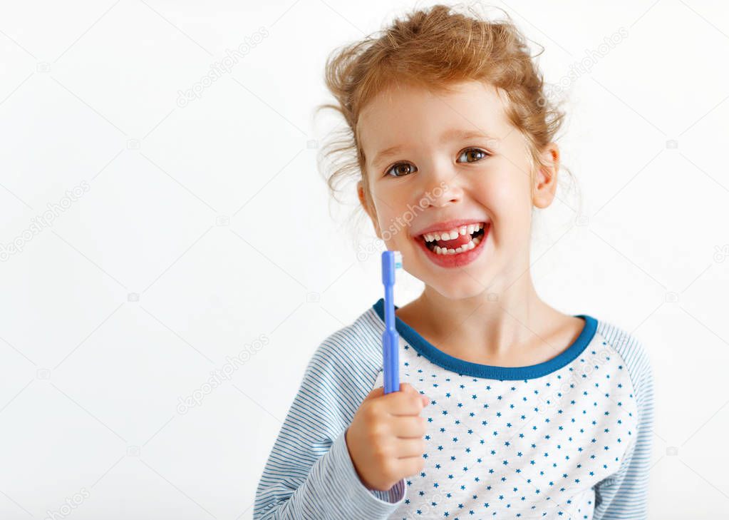 happy child girl smiles with toothbrush    