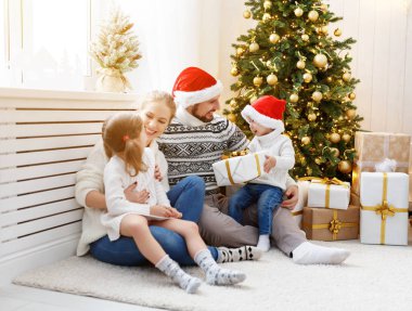 aile anne baba ve Noel sabahı evde çocuklar