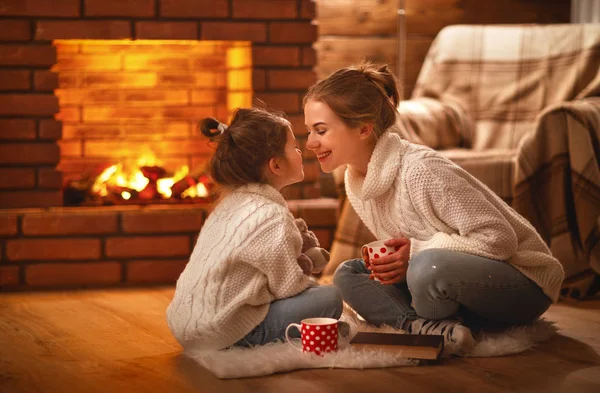 Family mother and child drinking tea and laughing on winter even Stock Photo