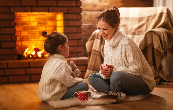 Family mother and child drinking tea and laughing on winter even Stock Image