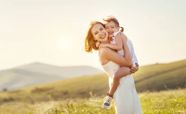 Happy family in summer outdoors.   mother  hug child daughter an — Stock Photo, Image