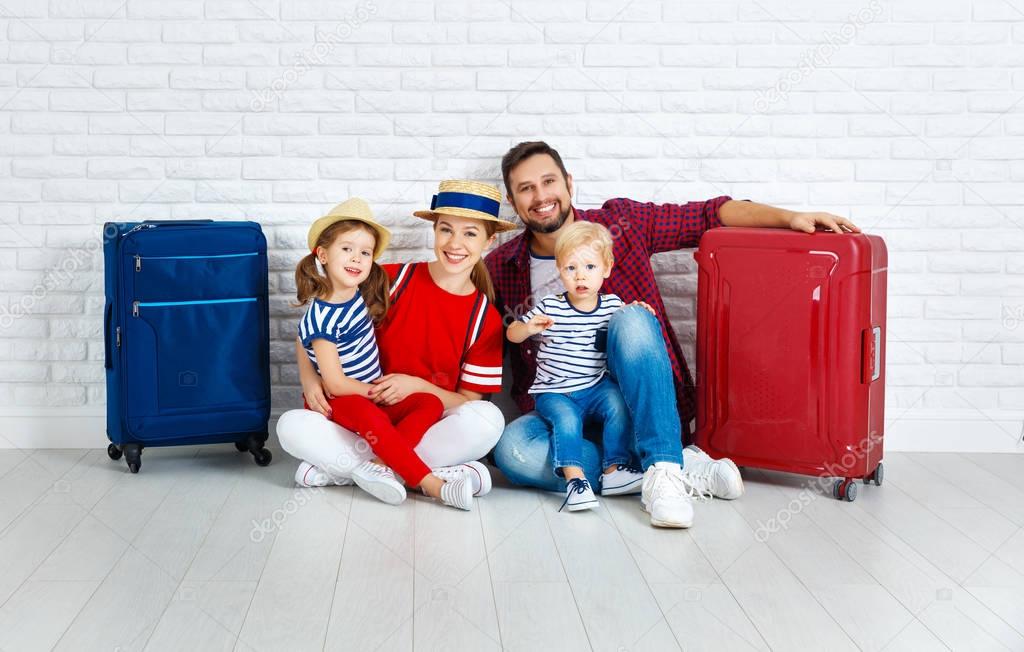 concept travel and tourism. happy family with suitcases near   w