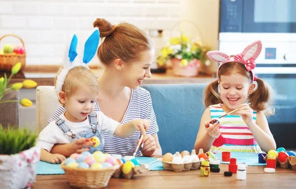 Happy easter! family mother and children paint eggs for   holida