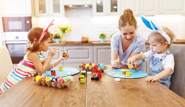 Happy easter! family mother and children paint eggs for   holida