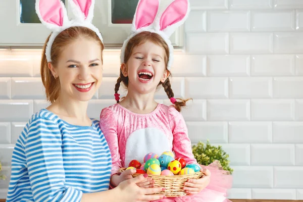 Happy easter! family mother and child daughter with ears hare getting ready for holida