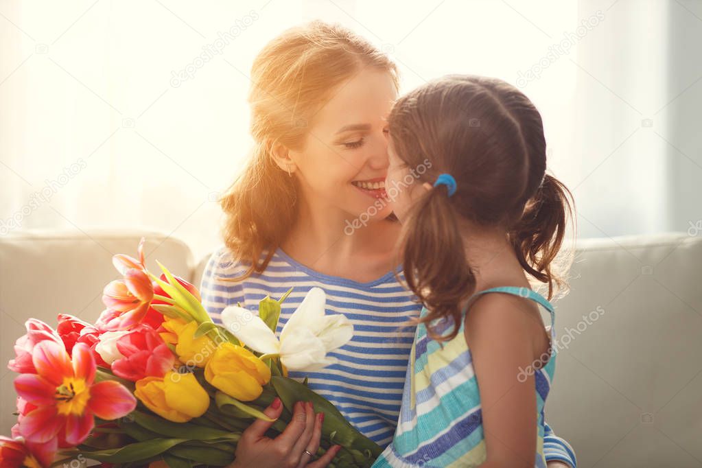 happy mother's day! child daughter   gives mother a bouquet of f