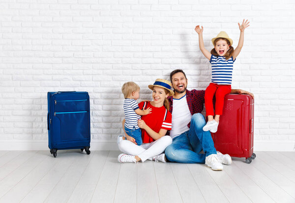 concept travel and tourism. happy family with suitcases near   w