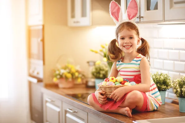 Happy easter! funny child girl with rabbit ears and  basket   of