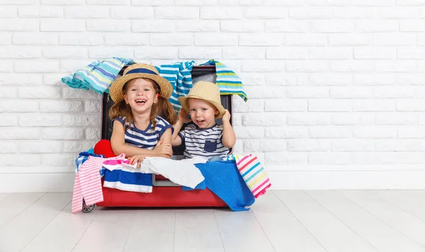 Happy laughing children  with suitcase going on a trip — Stock Photo, Image