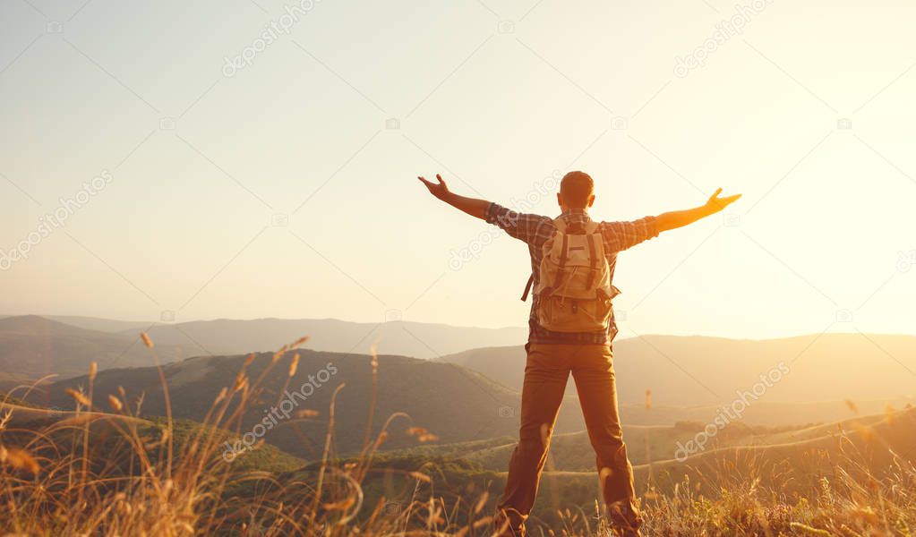 Male tourist on top of mountain in fog in autumn