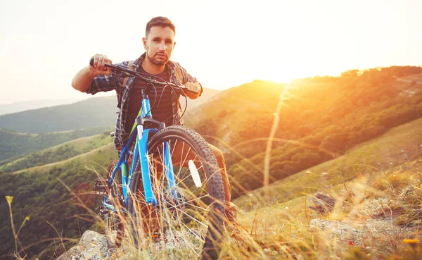 Cycling. young man with bicycle on nature in mountains — Stock Photo, Image